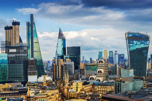 ndon, England - Panoramic skyline view of Bank and Canary Wharf, central London's leading financial districts with famous skyscrapers at golden hour sunset with blue sky and clouds