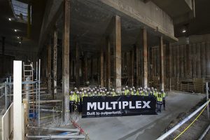 Workers holding a Multiplex sign