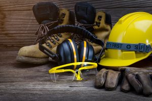 Health and safety gear including a hard hat, ear protectors and boots